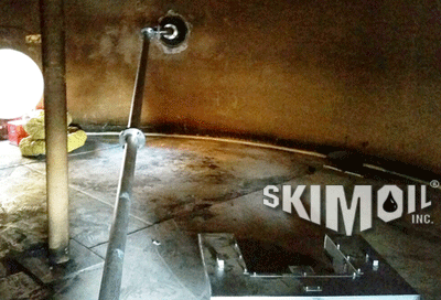 Swing Arm Oil Skimmer deployed in a enclosed tank